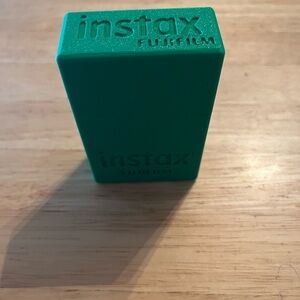Fujifilm Instax Inspired Green Case for pictures made by us with our 3D Printer.
